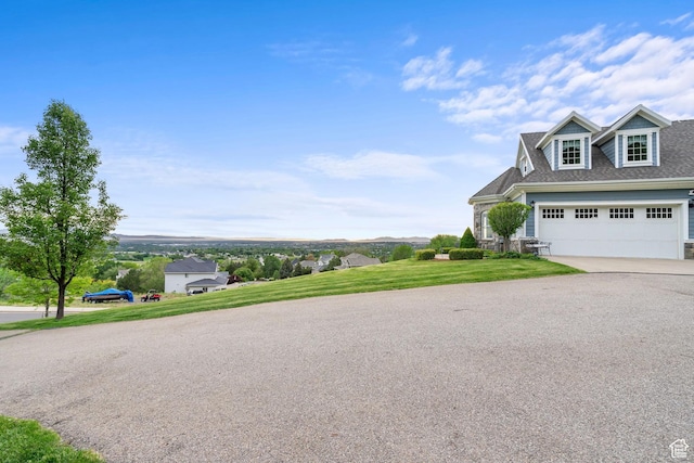 3291 E 1300 N, Layton, UT 84040 - view of side of property featuring concrete driveway, a garage, a lawn, and a shingled roof