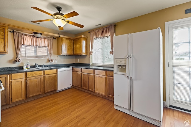 154 E 950 N, Glenwood, UT 84730 - kitchen with white appliances, brown cabinets, a sink, and light wood finished floors