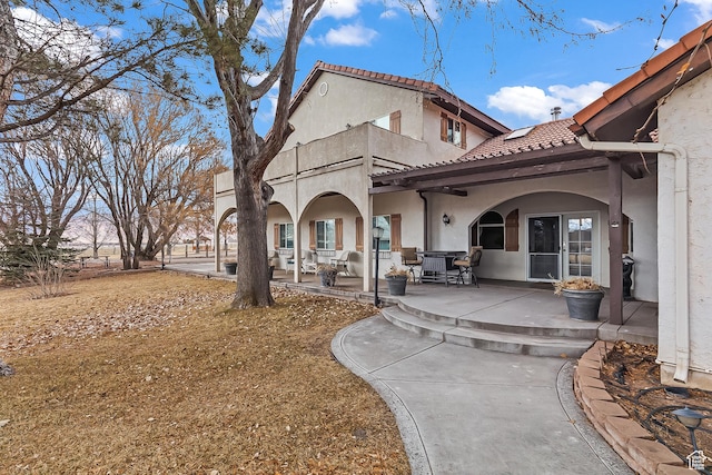 154 E 950 N, Glenwood, UT 84730 - back of house with stucco siding, a balcony, a tiled roof, and a patio area