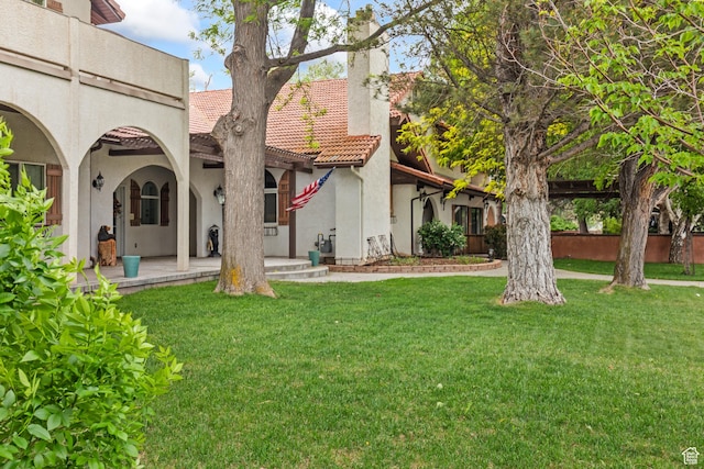 154 E 950 N, Glenwood, UT 84730 - back of property with stucco siding, a chimney, a tile roof, and a yard