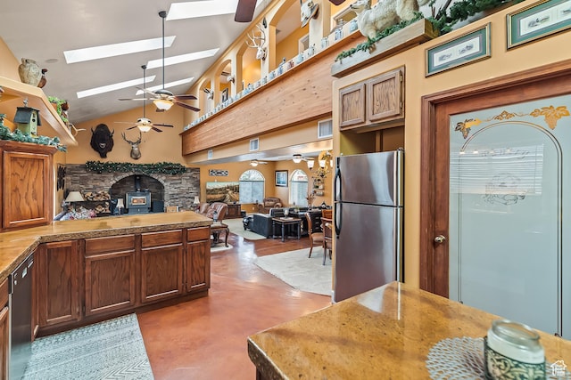 154 E 950 N, Glenwood, UT 84730 - kitchen with stainless steel appliances, ceiling fan, a skylight, finished concrete flooring, and high vaulted ceiling