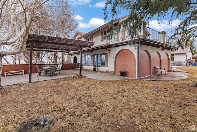 154 E 950 N, Glenwood, UT 84730 - back of property with a pergola, a balcony, stucco siding, and a patio area