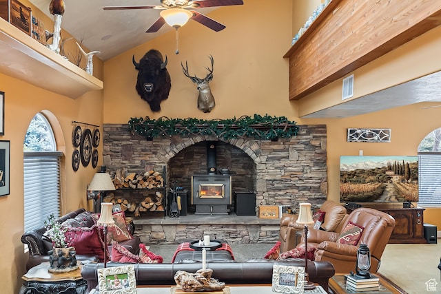 154 E 950 N, Glenwood, UT 84730 - living area featuring a ceiling fan, a wood stove, high vaulted ceiling, and carpet flooring