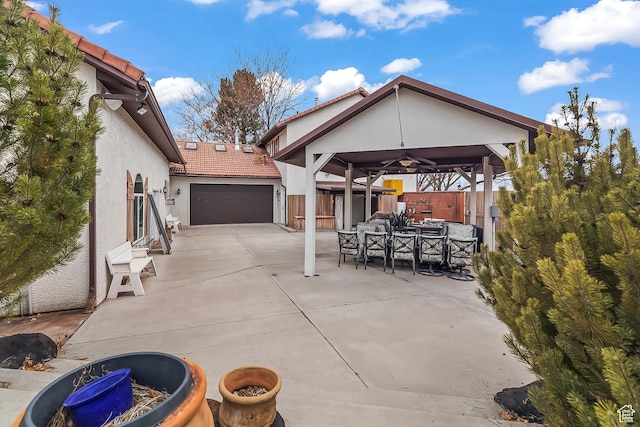154 E 950 N, Glenwood, UT 84730 - view of patio featuring a garage, outdoor dining space, concrete driveway, and a ceiling fan