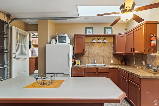 154 E 950 N, Glenwood, UT 84730 - kitchen with freestanding refrigerator, a sink, tasteful backsplash, and a ceiling fan