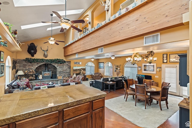 154 E 950 N, Glenwood, UT 84730 - kitchen featuring ceiling fan, a skylight, open floor plan, a wood stove, and plenty of natural light