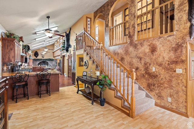 154 E 950 N, Glenwood, UT 84730 - stairs with wood finished floors, a ceiling fan, arched walkways, and high vaulted ceiling