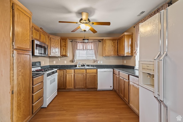 154 E 950 N, Glenwood, UT 84730 - kitchen featuring white appliances, a sink, dark countertops, and light wood-style flooring