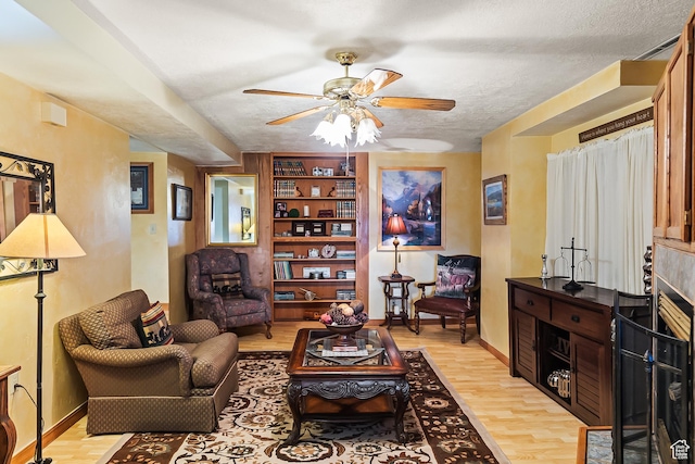 154 E 950 N, Glenwood, UT 84730 - living room featuring ceiling fan, light wood-style floors, a textured ceiling, and baseboards