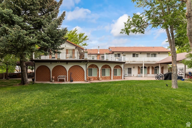 154 E 950 N, Glenwood, UT 84730 - back of house featuring a balcony, a lawn, stucco siding, and a patio area