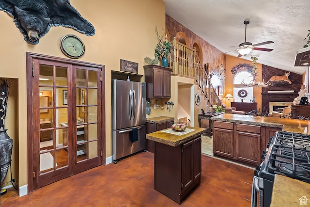 154 E 950 N, Glenwood, UT 84730 - kitchen with appliances with stainless steel finishes, lofted ceiling, a ceiling fan, a fireplace, and a center island