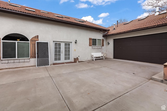 154 E 950 N, Glenwood, UT 84730 - back of property with stucco siding, a tile roof, french doors, and concrete driveway