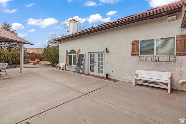 154 E 950 N, Glenwood, UT 84730 - back of property featuring french doors, a patio, a chimney, and stucco siding