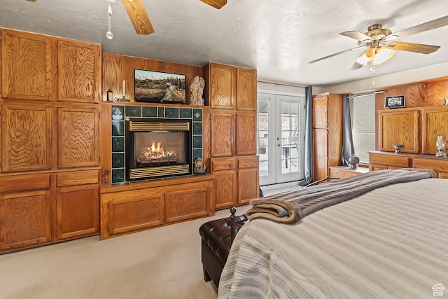 154 E 950 N, Glenwood, UT 84730 - carpeted bedroom with access to exterior, a tiled fireplace, and ceiling fan