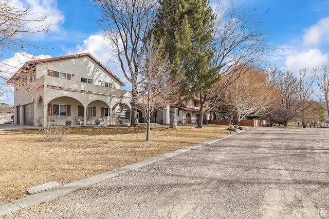 154 E 950 N, Glenwood, UT 84730 - exterior space featuring a porch, a balcony, stucco siding, driveway, and a garage