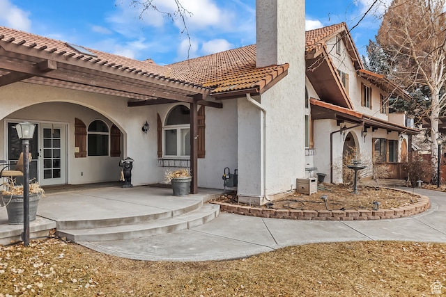 154 E 950 N, Glenwood, UT 84730 - back of house featuring a chimney, a tile roof, stucco siding, a patio, and a pergola