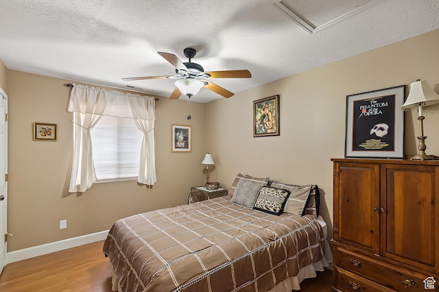 154 E 950 N, Glenwood, UT 84730 - bedroom with wood finished floors, baseboards, a textured ceiling, attic access, and a ceiling fan