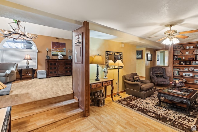 154 E 950 N, Glenwood, UT 84730 - living room with light wood-style floors, a chandelier, baseboards, and ceiling fan