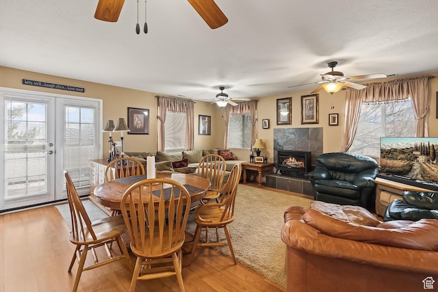 154 E 950 N, Glenwood, UT 84730 - dining space with ceiling fan, light wood finished floors, healthy amount of natural light, and a tiled fireplace