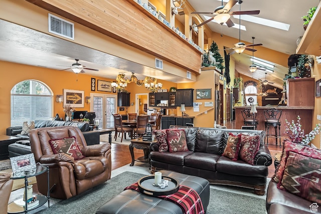 154 E 950 N, Glenwood, UT 84730 - living area featuring ceiling fan, a chandelier, a skylight, and vaulted ceiling