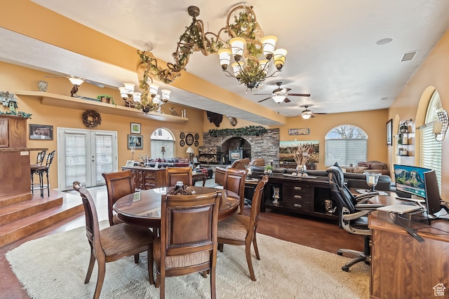 154 E 950 N, Glenwood, UT 84730 - dining space featuring a ceiling fan, a chandelier, a desk, a fireplace, and dark carpet