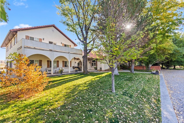 154 E 950 N, Glenwood, UT 84730 - back of house with a balcony, stucco siding, a yard, and a porch