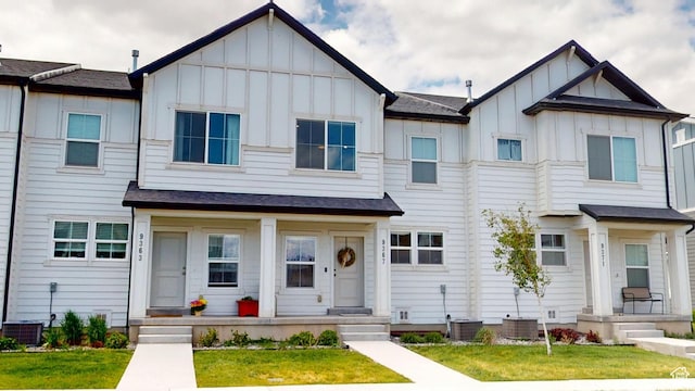 9367 N Vernham Way E, Eagle Mountain, UT 84005 - view of property with board and batten siding, cooling unit, a porch, and a front yard