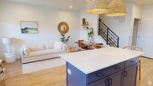 9367 N Vernham Way E, Eagle Mountain, UT 84005 - kitchen featuring light wood-style floors, recessed lighting, a kitchen breakfast bar, light countertops, and open floor plan