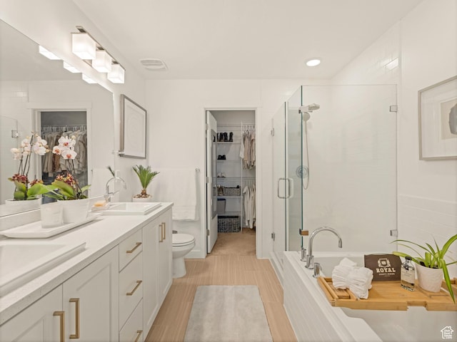 1512 W Fiore St, Farmington, UT 84025 - bathroom featuring double vanity, a walk in closet, a garden tub, and a stall shower