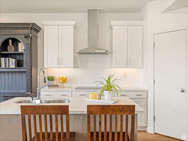 1512 W Fiore St, Farmington, UT 84025 - kitchen with wall chimney range hood, a sink, white cabinets, and light countertops