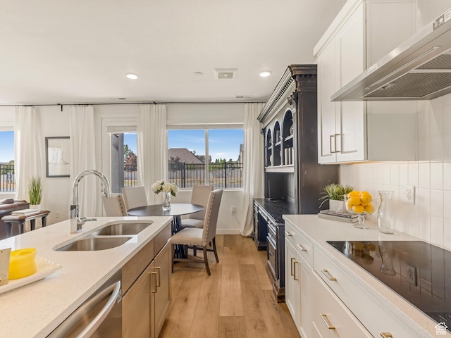 1512 W Fiore St, Farmington, UT 84025 - kitchen featuring a sink, range hood, black electric stovetop, light wood-style flooring, and recessed lighting