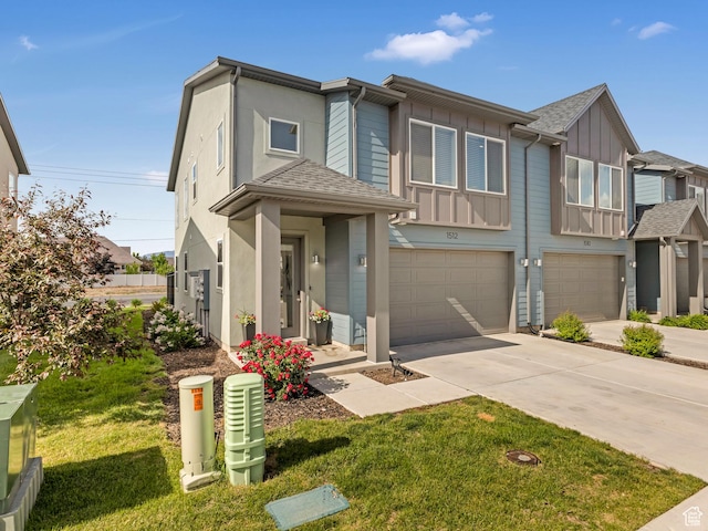 1512 W Fiore St, Farmington, UT 84025 - view of front facade featuring board and batten siding, a garage, driveway, and a front yard