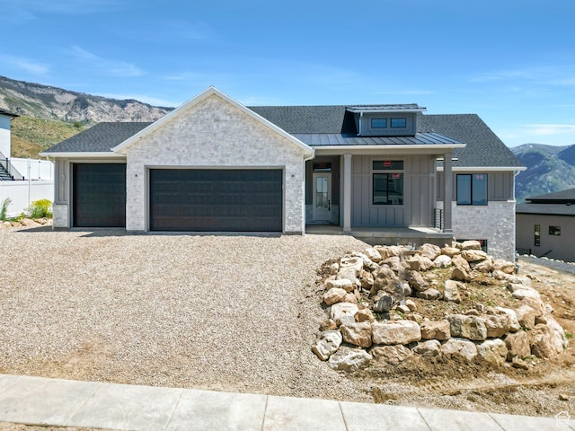 4280 N 100 E, North Ogden, UT 84414 - view of front of home with a porch, an attached garage, board and batten siding, gravel driveway, and a mountain view
