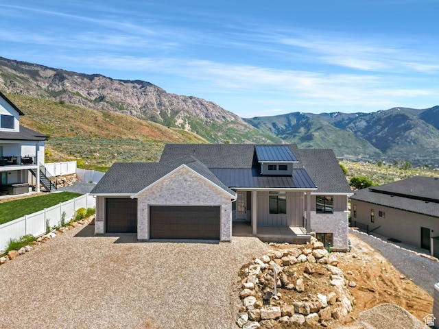 4280 N 100 E, North Ogden, UT 84414 - modern inspired farmhouse with a standing seam roof, an attached garage, gravel driveway, and a mountain view