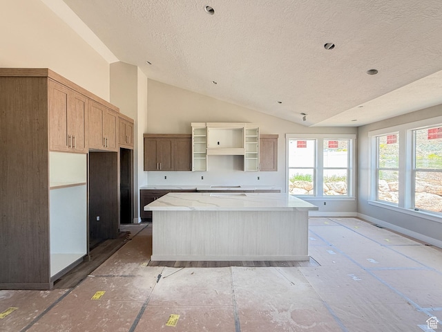 4280 N 100 E, North Ogden, UT 84414 - kitchen with a textured ceiling, a kitchen island, vaulted ceiling, open shelves, and light stone countertops