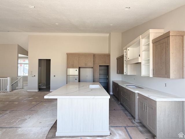 4280 N 100 E, North Ogden, UT 84414 - kitchen featuring stovetop, a center island, a textured ceiling, light stone countertops, and open shelves