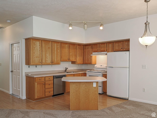 130 Bamberger Rd, North Salt Lake, UT 84054 - kitchen with white appliances, a sink, under cabinet range hood, light countertops, and light wood-style flooring