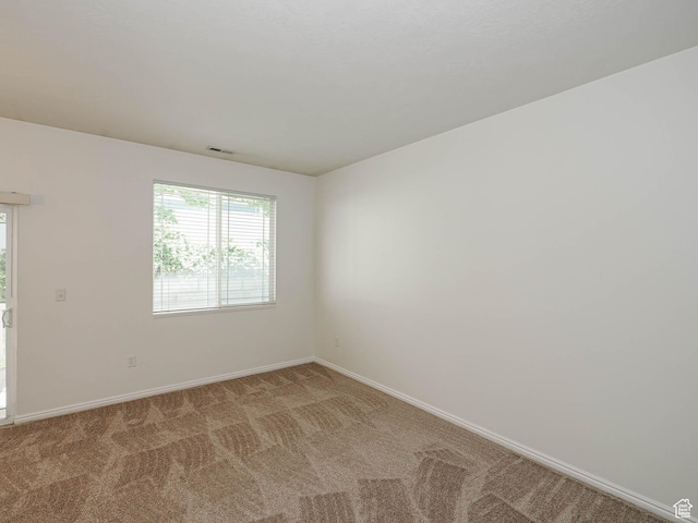 130 Bamberger Rd, North Salt Lake, UT 84054 - carpeted empty room with baseboards