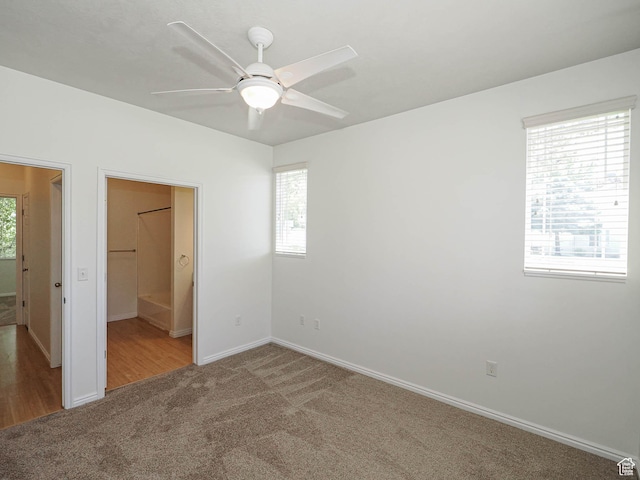 130 Bamberger Rd, North Salt Lake, UT 84054 - unfurnished bedroom featuring carpet floors, multiple windows, baseboards, and ceiling fan