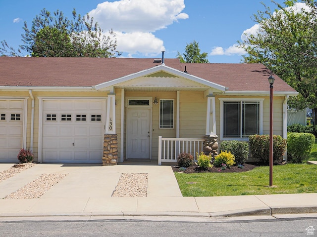 130 Bamberger Rd, North Salt Lake, UT 84054 - view of front of home with driveway, a garage, and covered porch