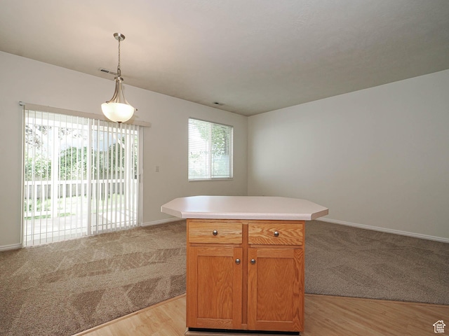 130 Bamberger Rd, North Salt Lake, UT 84054 - kitchen with light colored carpet, open floor plan, and hanging light fixtures