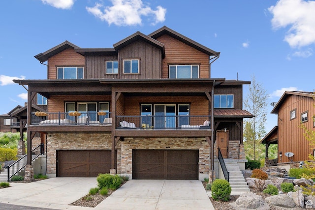 1757 E Longview Dr Unit 87, Hideout, UT 84036 - view of front facade featuring stairs, stone siding, an attached garage, driveway, and a balcony