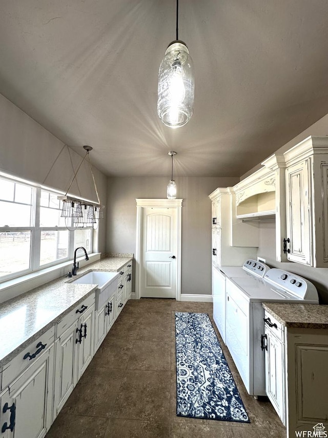 1471 N 3500 E, Ballard, UT 84066 - kitchen with washing machine and clothes dryer, a sink, pendant lighting, and baseboards