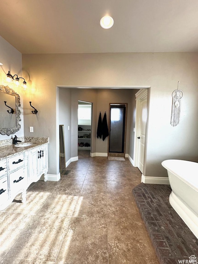 1471 N 3500 E, Ballard, UT 84066 - full bathroom featuring vanity, a soaking tub, a spacious closet, and baseboards