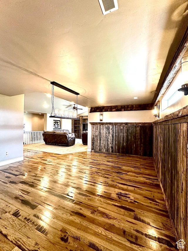1471 N 3500 E, Ballard, UT 84066 - unfurnished living room featuring hardwood / wood-style floors, ceiling fan, vaulted ceiling, and a fireplace