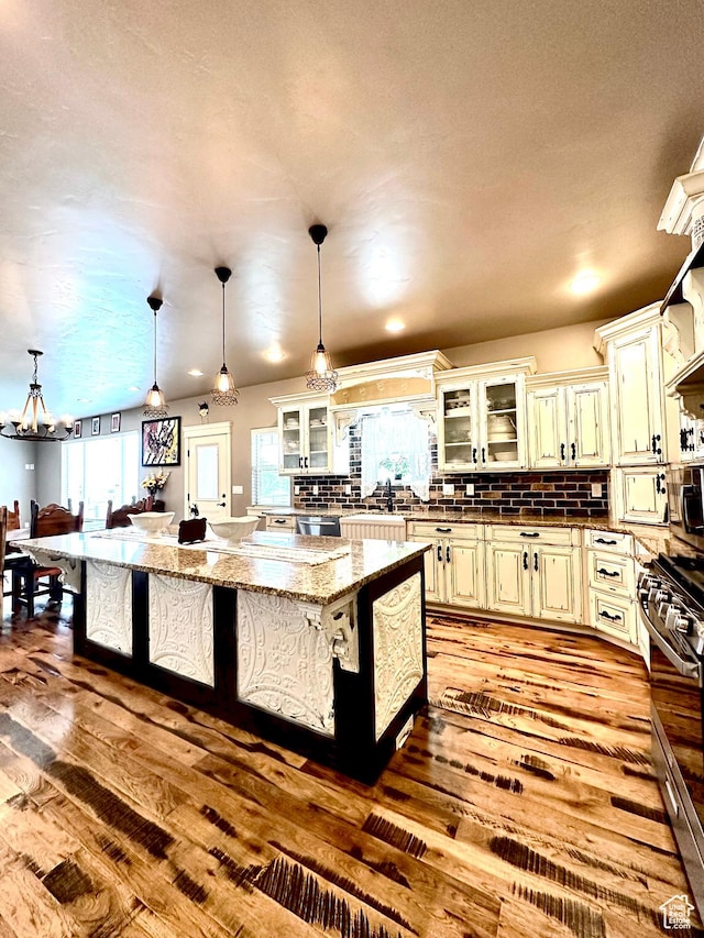 1471 N 3500 E, Ballard, UT 84066 - kitchen with dark wood-style floors, a chandelier, stainless steel appliances, backsplash, and light stone countertops