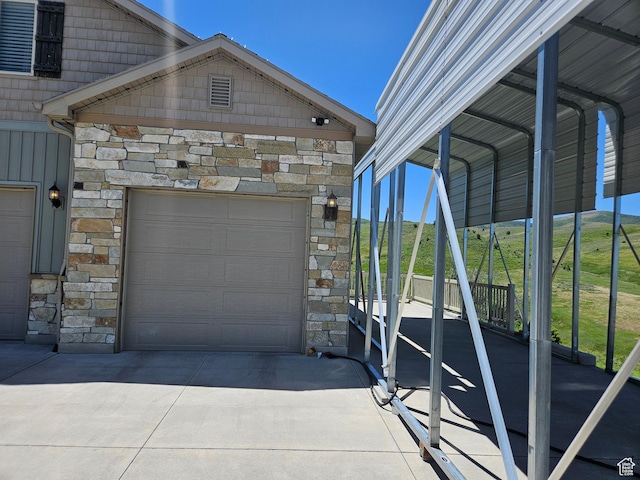 13695 Highlander Cir, Beaverdam, UT 84306 - garage with concrete driveway and a detached carport