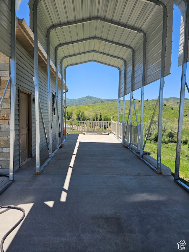 13695 Highlander Cir, Beaverdam, UT 84306 - view of parking featuring a mountain view, driveway, and a carport