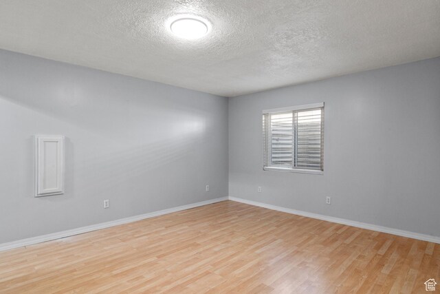 8793 S Mountain Vista Dr, West Jordan, UT 84081 - unfurnished room featuring wood finished floors, baseboards, and a textured ceiling