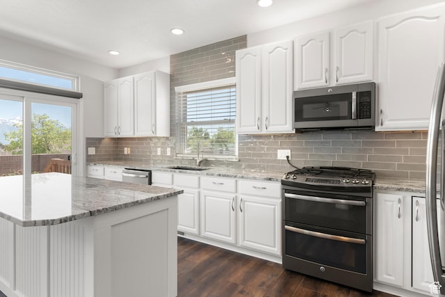 8793 S Mountain Vista Dr, West Jordan, UT 84081 - kitchen featuring stainless steel appliances, a sink, recessed lighting, backsplash, and white cabinets